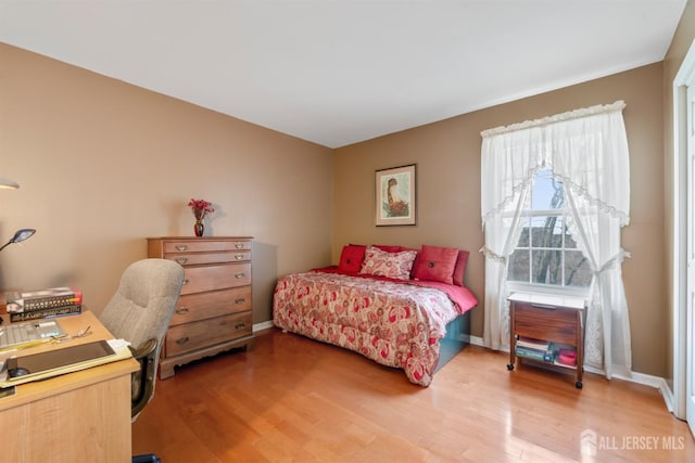 bedroom featuring baseboards and light wood-style floors