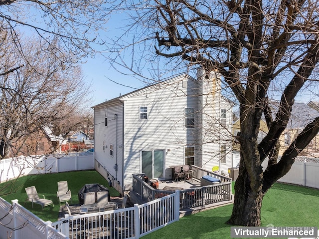 view of side of home with a yard, a fenced backyard, and a chimney