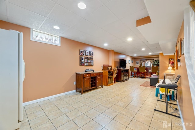 office featuring light tile patterned flooring, a drop ceiling, recessed lighting, and baseboards