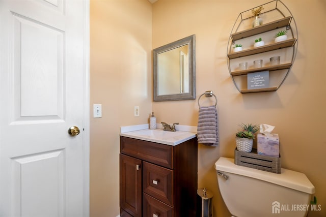 bathroom featuring toilet and vanity