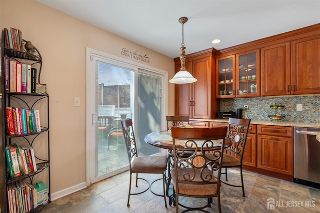 dining room with recessed lighting, stone finish floor, and baseboards