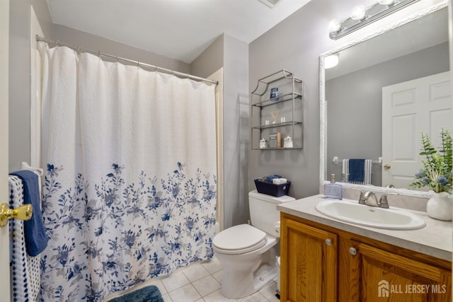 bathroom with tile patterned floors, toilet, a shower with shower curtain, and vanity