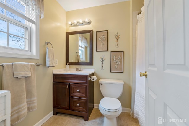 full bathroom with tile patterned flooring, toilet, vanity, and baseboards