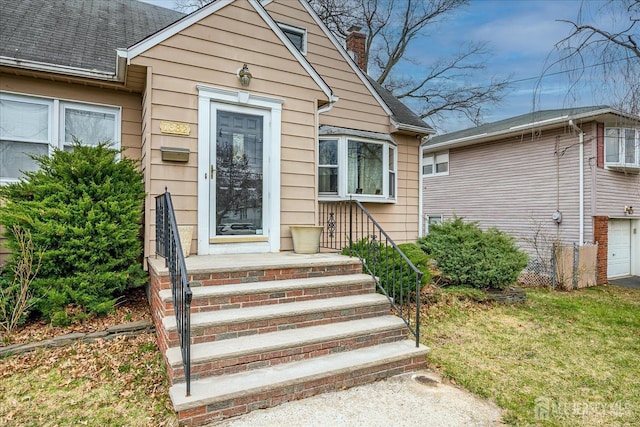 1332 Crescent Ave, Roselle, NJ 07203 - view of exterior entry with a chimney and roof with shingles