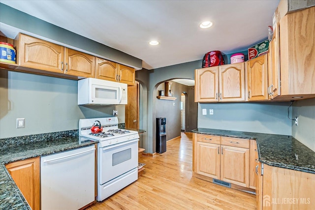 1332 Crescent Ave, Roselle, NJ 07203 - kitchen with white appliances, arched walkways, light wood-style flooring, recessed lighting, and dark stone counters