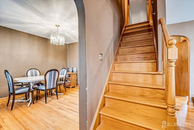 1332 Crescent Ave, Roselle, NJ 07203 - stairs with arched walkways, wood finished floors, baseboards, and a chandelier
