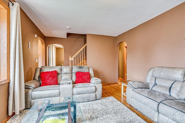 1332 Crescent Ave, Roselle, NJ 07203 - living area with arched walkways, wood finished floors, stairs, and baseboards