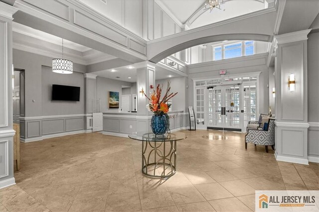 interior space featuring ornate columns and ornamental molding