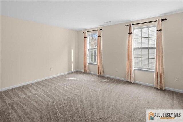 unfurnished room with light carpet