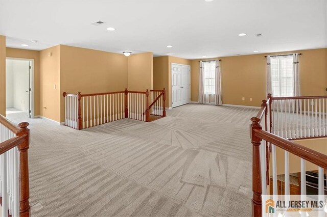 empty room with light colored carpet