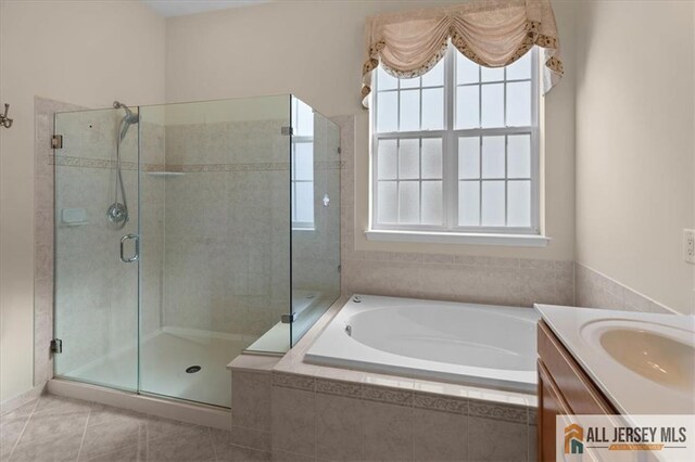 bathroom featuring vanity, tile patterned flooring, and independent shower and bath