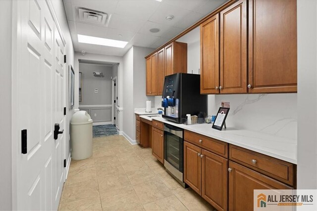 kitchen with a drop ceiling and backsplash