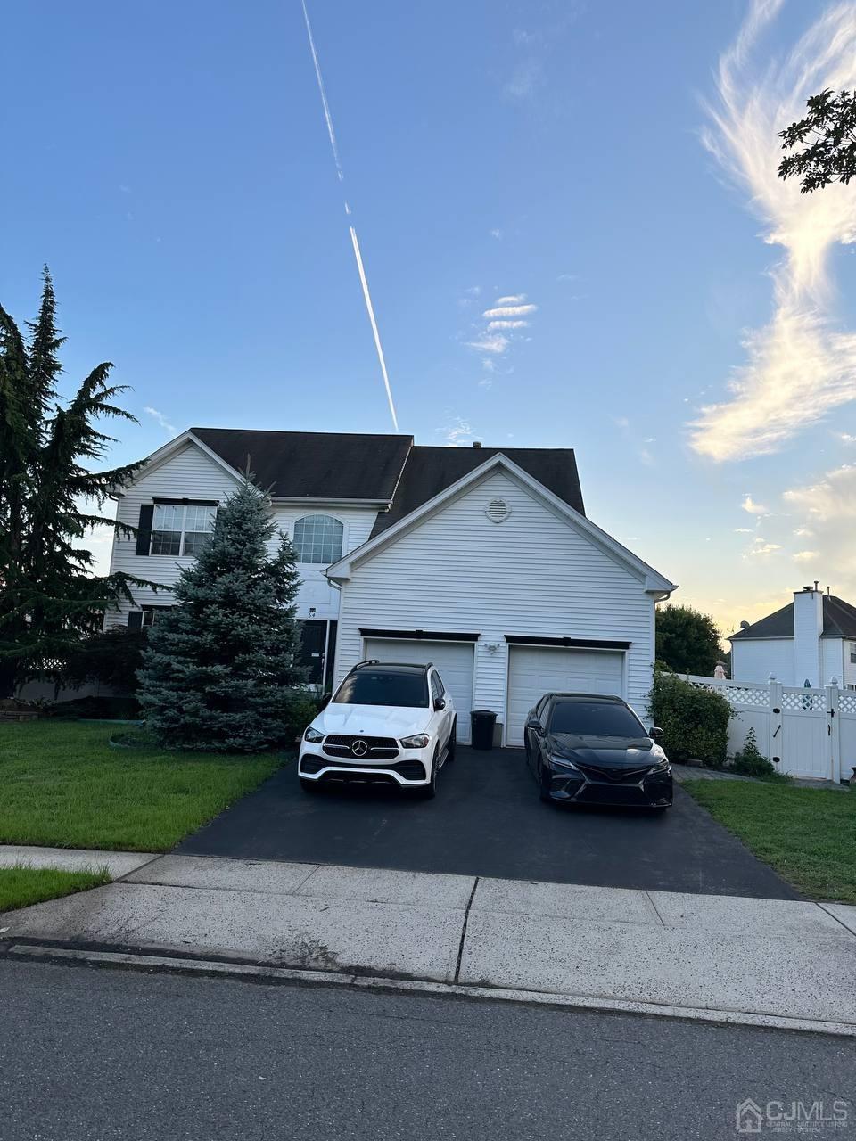 view of front of property featuring a garage and a front lawn