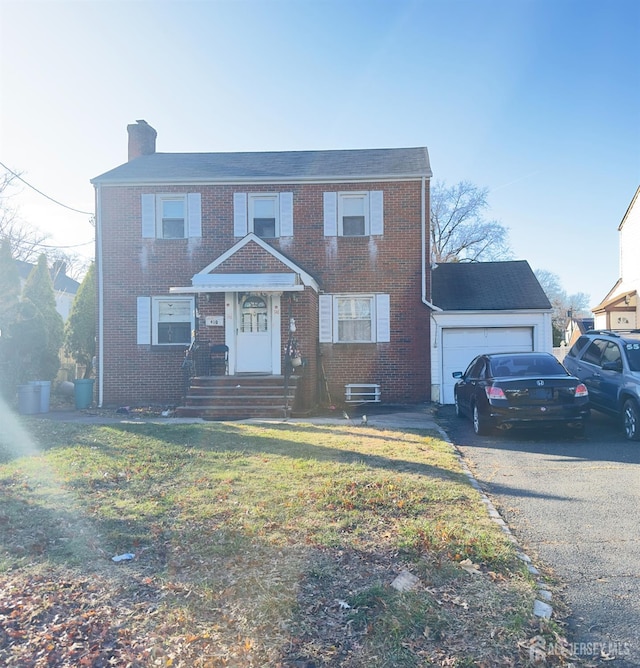 910 Roanoke Ave, Hillside, NJ 07205 - view of front facade featuring brick siding, a chimney, an attached garage, driveway, and a front lawn
