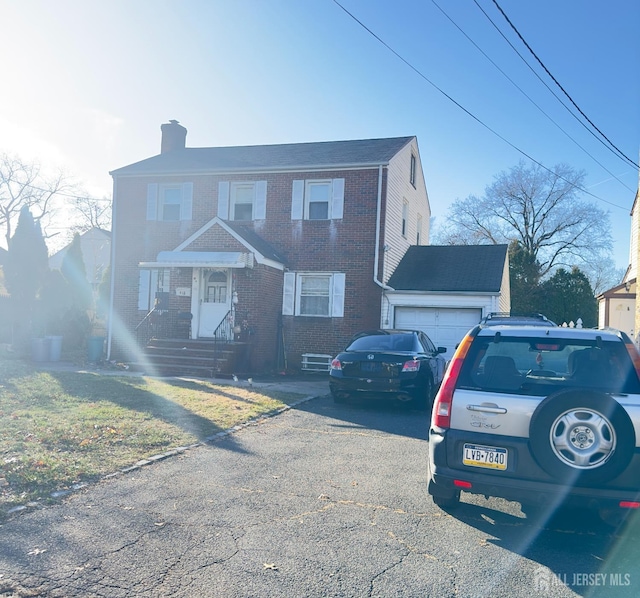 910 Roanoke Ave, Hillside, NJ 07205 - view of front of home with a garage, driveway, a chimney, and brick siding
