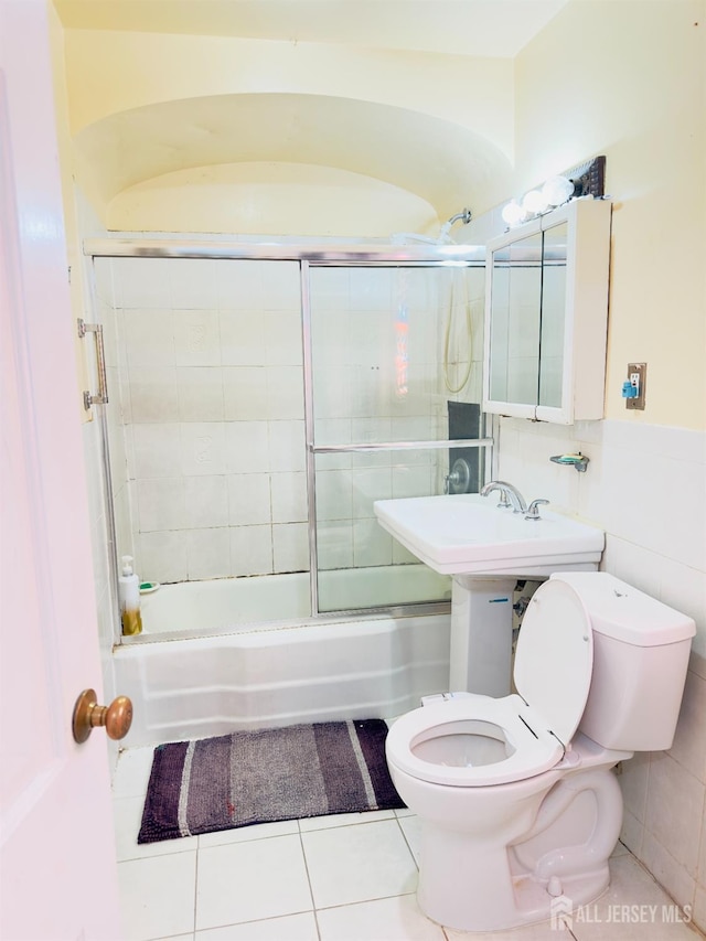 910 Roanoke Ave, Hillside, NJ 07205 - full bath with toilet, bath / shower combo with glass door, tile patterned flooring, and tile walls
