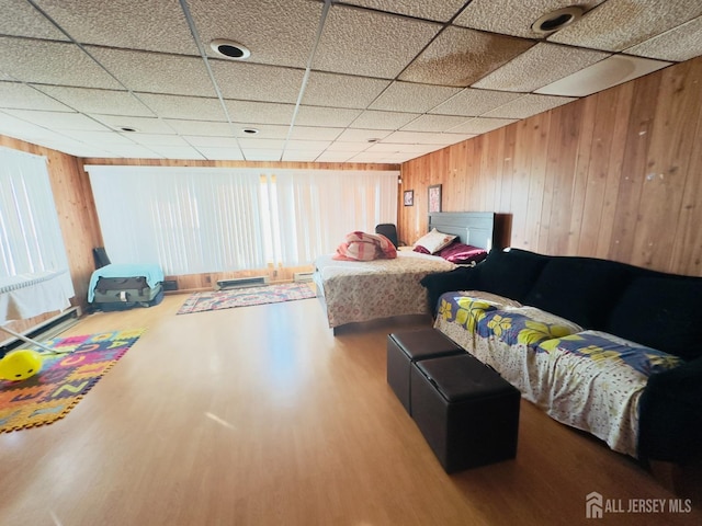 910 Roanoke Ave, Hillside, NJ 07205 - bedroom featuring wood finished floors, wooden walls, a drop ceiling, and multiple windows