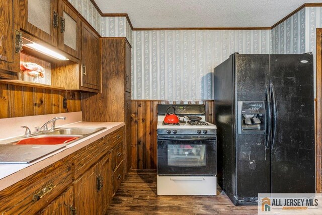 14 Fisher Ave, Middlesex, NJ 08846 - kitchen featuring black fridge, wallpapered walls, crown molding, range with gas cooktop, and a textured ceiling
