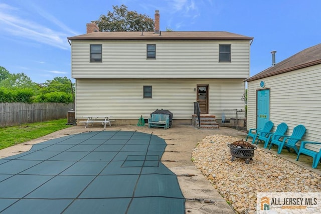 14 Fisher Ave, Middlesex, NJ 08846 - back of house featuring an outdoor fire pit, a patio, a chimney, and entry steps