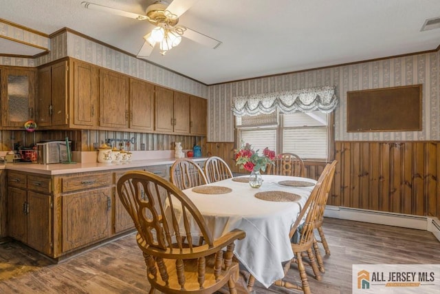 14 Fisher Ave, Middlesex, NJ 08846 - dining space featuring wallpapered walls, crown molding, wood finished floors, a wainscoted wall, and baseboard heating
