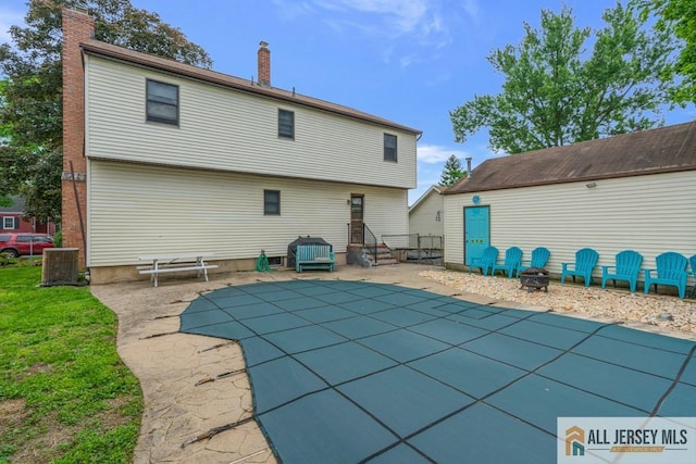 14 Fisher Ave, Middlesex, NJ 08846 - rear view of property featuring a chimney, a covered pool, and a patio