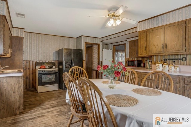 14 Fisher Ave, Middlesex, NJ 08846 - dining area featuring wallpapered walls, ceiling fan, wood finished floors, and crown molding