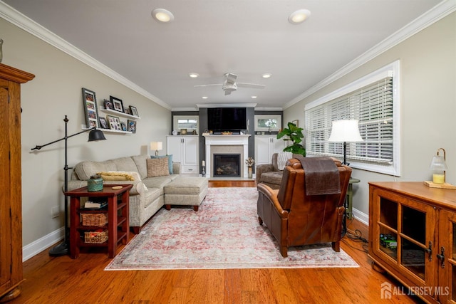 7 Manor Ct, Old Bridge, NJ 08857 - living room with a glass covered fireplace, wood finished floors, baseboards, ornamental molding, and recessed lighting