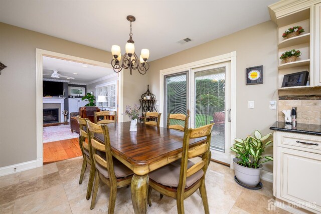 7 Manor Ct, Old Bridge, NJ 08857 - dining area with a chandelier, a fireplace, and baseboards