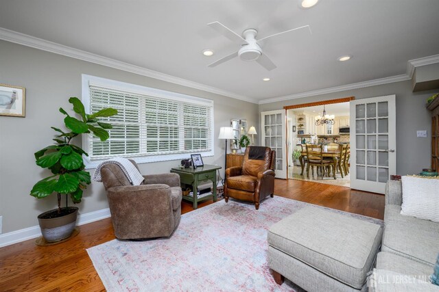 7 Manor Ct, Old Bridge, NJ 08857 - living area with a chandelier, crown molding, wood finished floors, ceiling fan, and recessed lighting