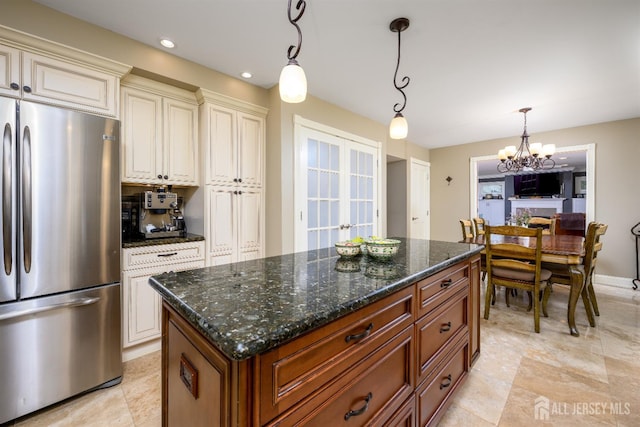 7 Manor Ct, Old Bridge, NJ 08857 - kitchen featuring freestanding refrigerator, a chandelier, decorative light fixtures, dark stone counters, and a center island