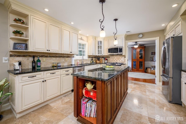 7 Manor Ct, Old Bridge, NJ 08857 - kitchen featuring open shelves, stainless steel appliances, cream cabinetry, a sink, and decorative backsplash