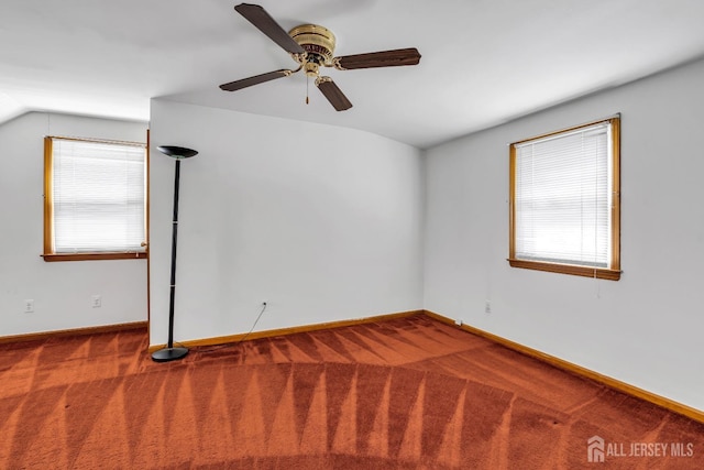 carpeted spare room with lofted ceiling, plenty of natural light, baseboards, and ceiling fan