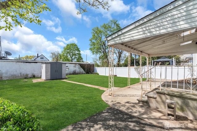 view of yard featuring a gazebo, a storage shed, a patio, and an outbuilding