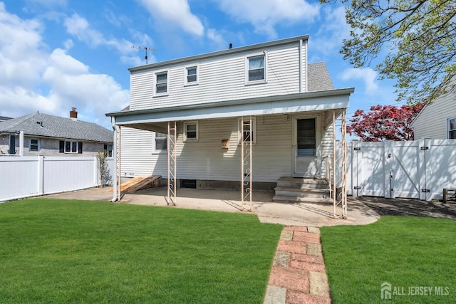 rear view of property featuring entry steps, a patio area, and a gate