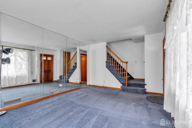 basement featuring stairway, baseboards, and carpet flooring