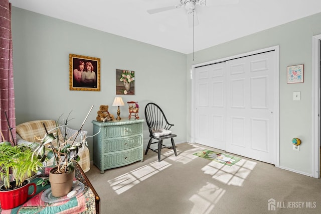 carpeted bedroom with ceiling fan, a closet, and baseboards