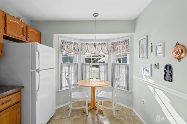 dining space featuring baseboards