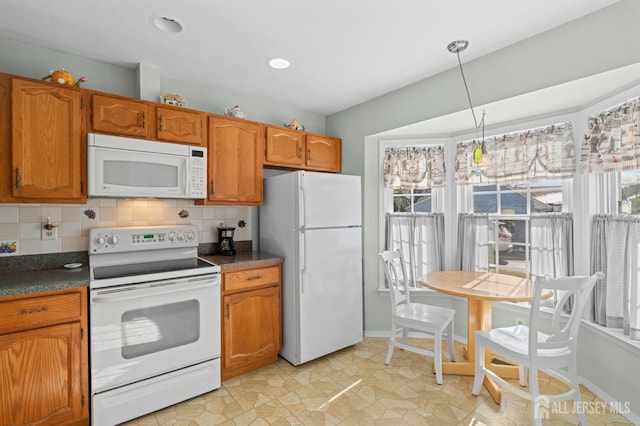 kitchen featuring white appliances, brown cabinetry, dark countertops, and decorative backsplash