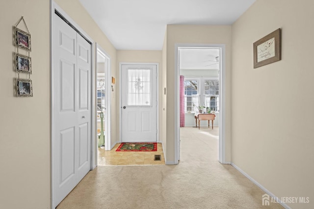 carpeted entryway with baseboards