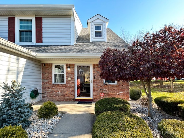 196 Jonathan Pl, Franklin Twsp, NJ 08873 - view of exterior entry with roof with shingles and brick siding