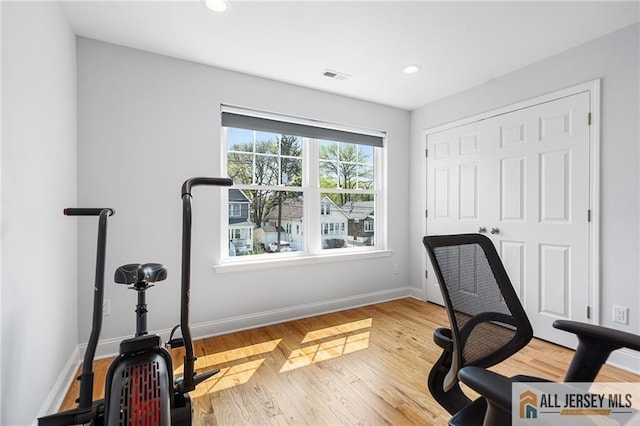 office space featuring baseboards, recessed lighting, and wood finished floors