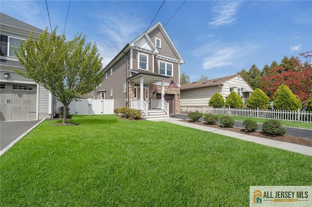 view of front of home featuring asphalt driveway, a gate, and a garage