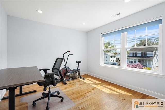 office space featuring baseboards, wood finished floors, and recessed lighting