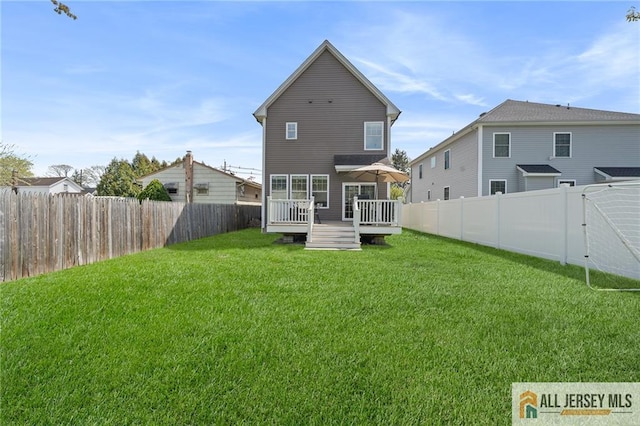 rear view of house featuring a wooden deck