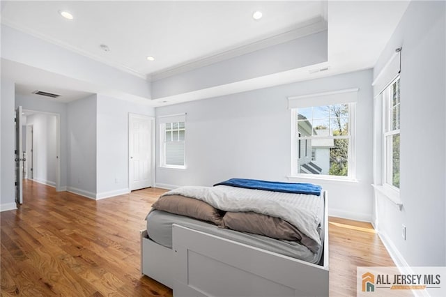 bedroom featuring ornamental molding, baseboards, wood finished floors, and recessed lighting