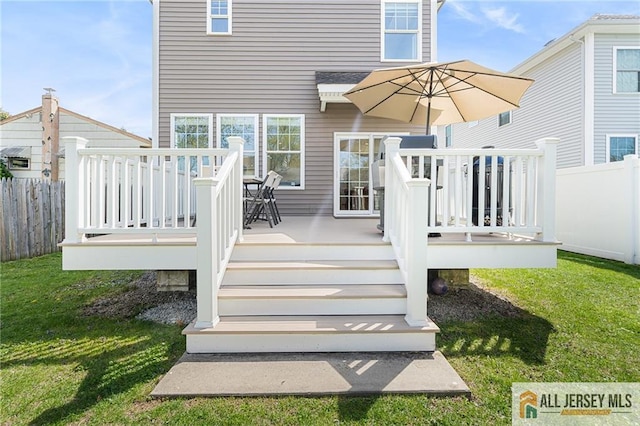 rear view of property featuring a deck