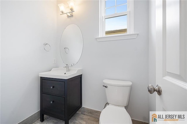 bathroom with toilet and vanity