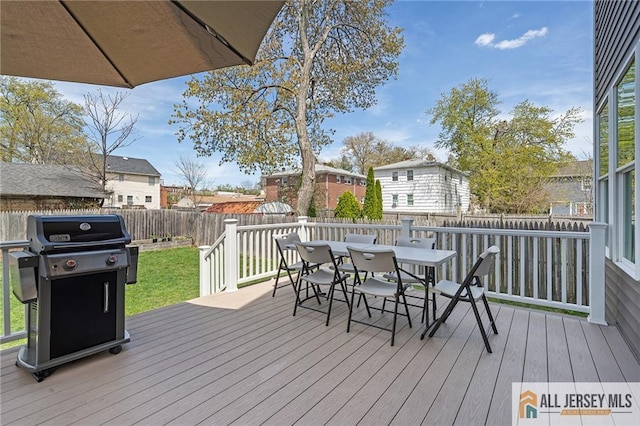 wooden deck featuring a grill