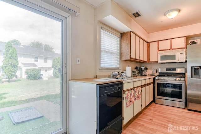 62 La Rue Ln, East Brunswick, NJ 08816 - kitchen featuring appliances with stainless steel finishes, light countertops, and light wood-style floors