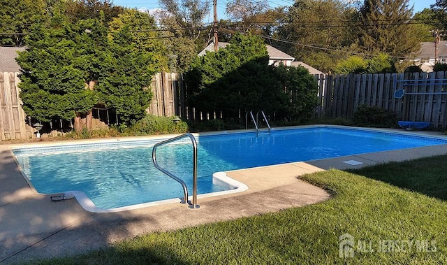 view of swimming pool featuring a fenced backyard and a fenced in pool